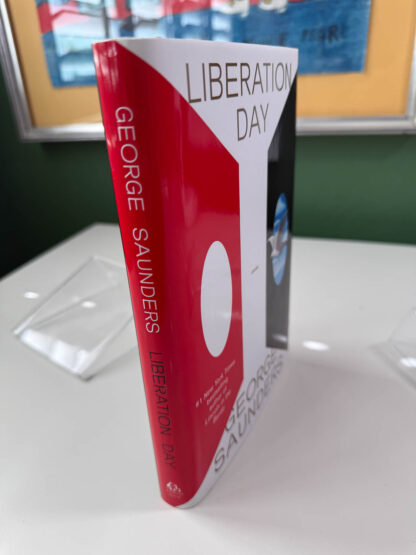 Various pictures of the signed first edition of George Saunders book Liberation Day