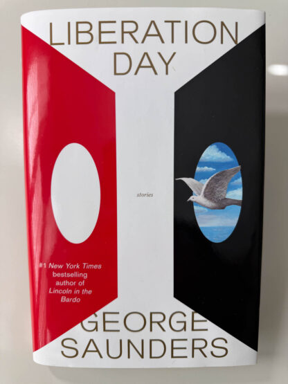 Various pictures of the signed first edition of George Saunders book Liberation Day