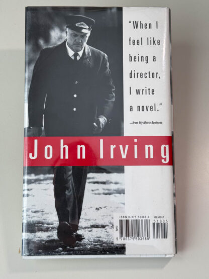 Various pictures of the John Irving memoir My Movie Business signed on the title page by the author.