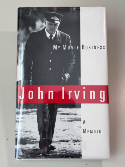 Various pictures of the John Irving memoir My Movie Business signed on the title page by the author.