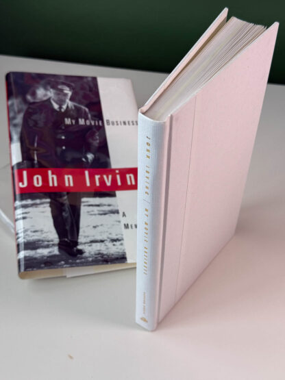 Various pictures of the John Irving memoir My Movie Business signed on the title page by the author.