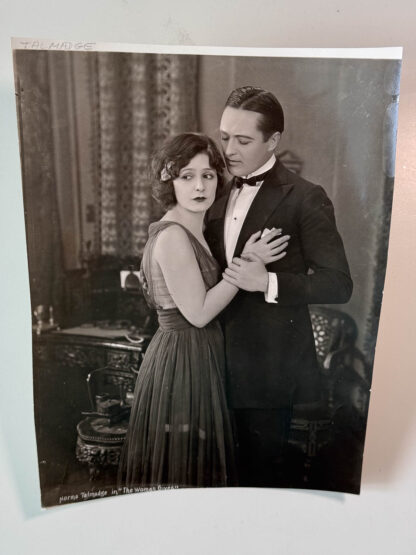 A picture of a promotional photo for the silent film "A Woman Gives" starring Norma Talmadge.